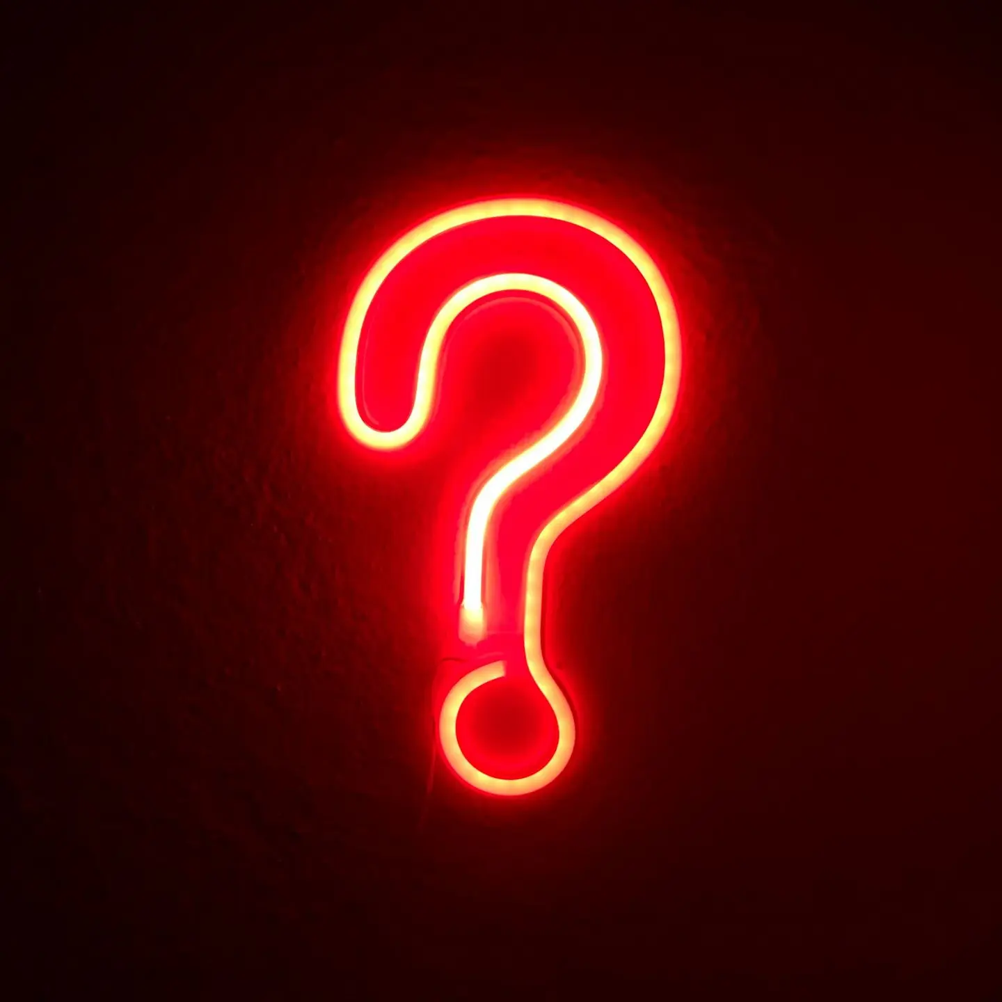 red neon question mark on wall