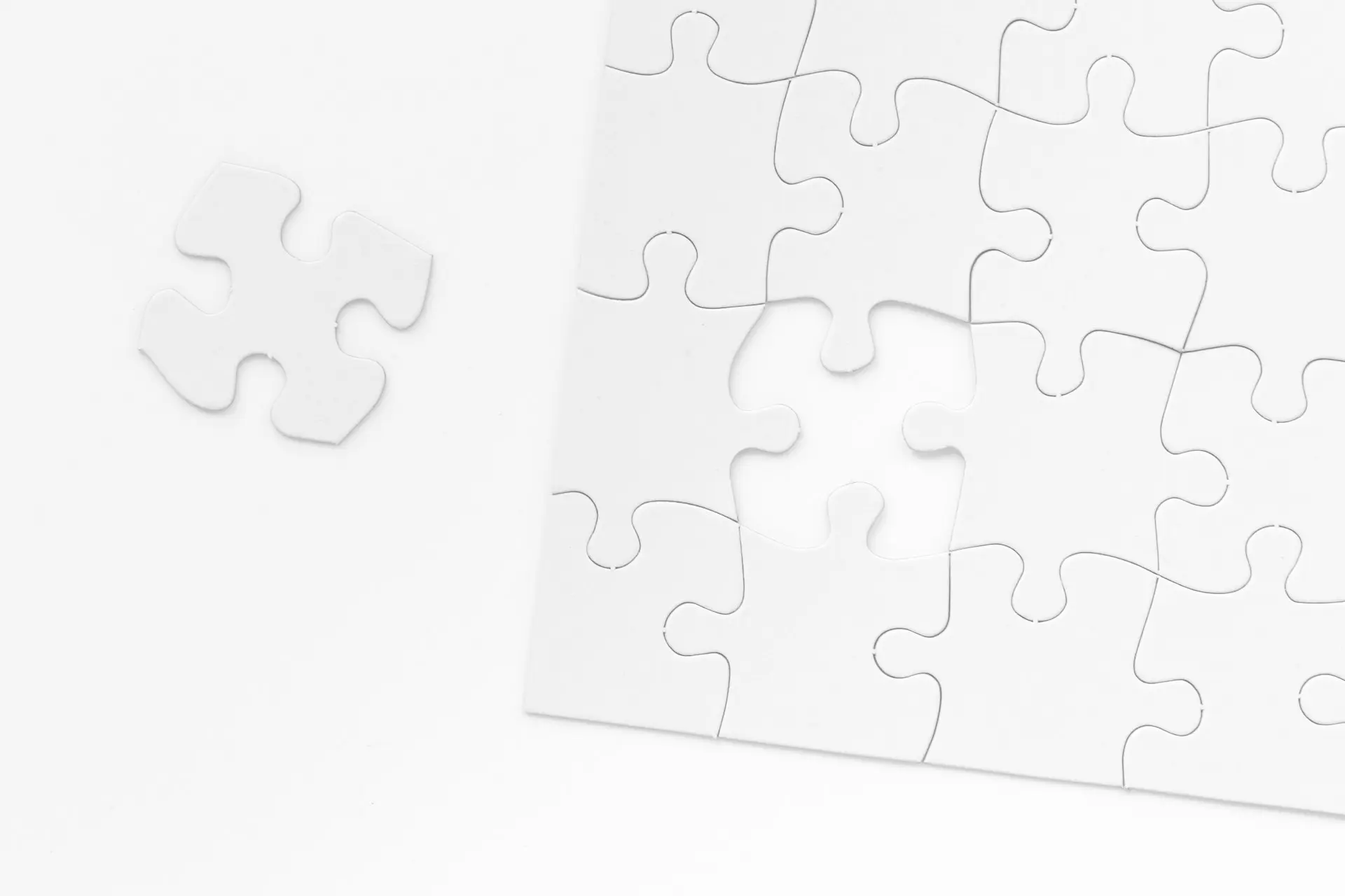 a piece of white puzzle sitting on top of a table